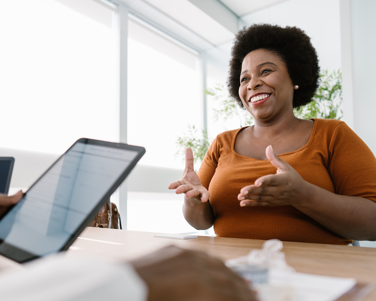 Woman sitting at a desk with a doctor